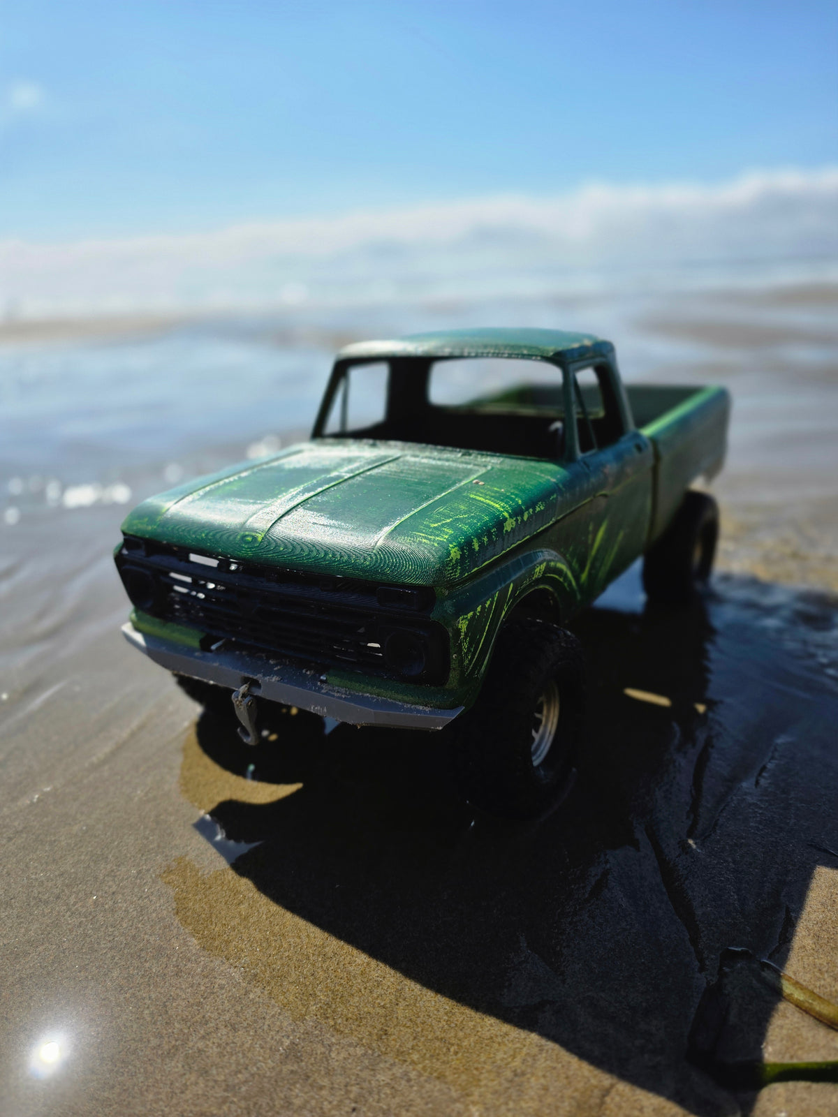 1963-66 Ford F100 painted RC body and mounts on BBV5 chassis, close-up front angle on wet sand