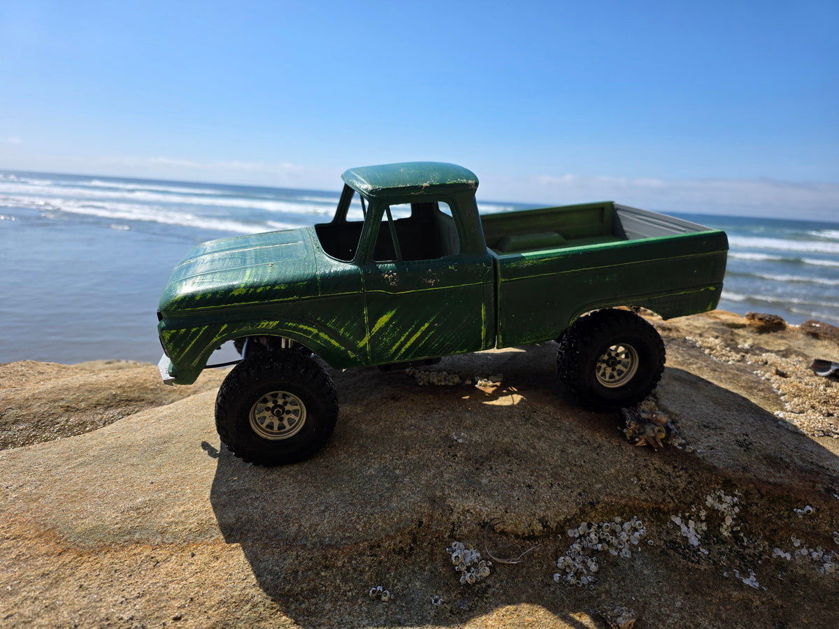 1963-66 Ford F100 painted RC body and mounts on BBV5 chassis, side profile on coastal rock