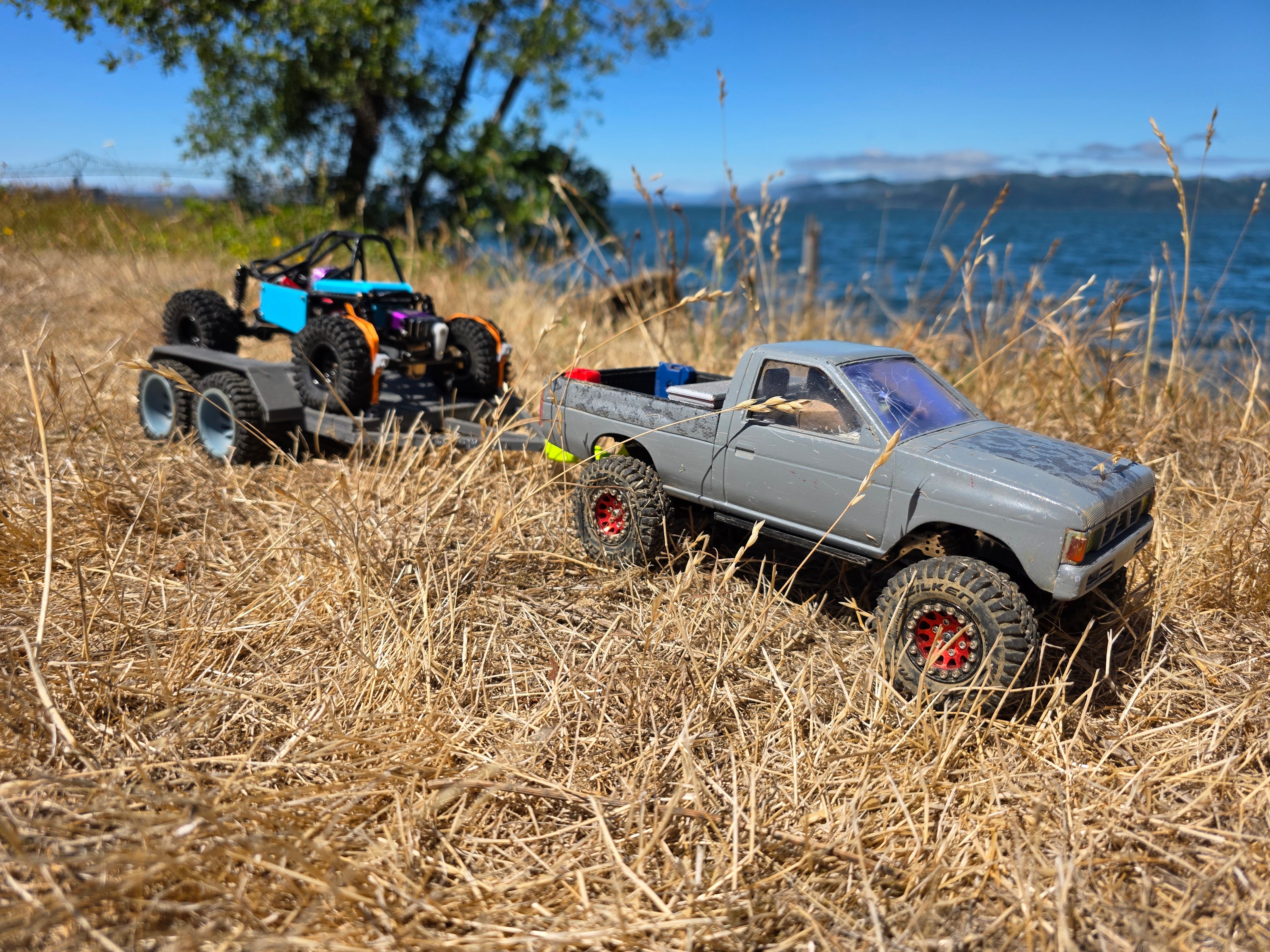 1/24 scale Nissan D21 RC pickup truck with GRC Mallard buggy on trailer, Columbia River