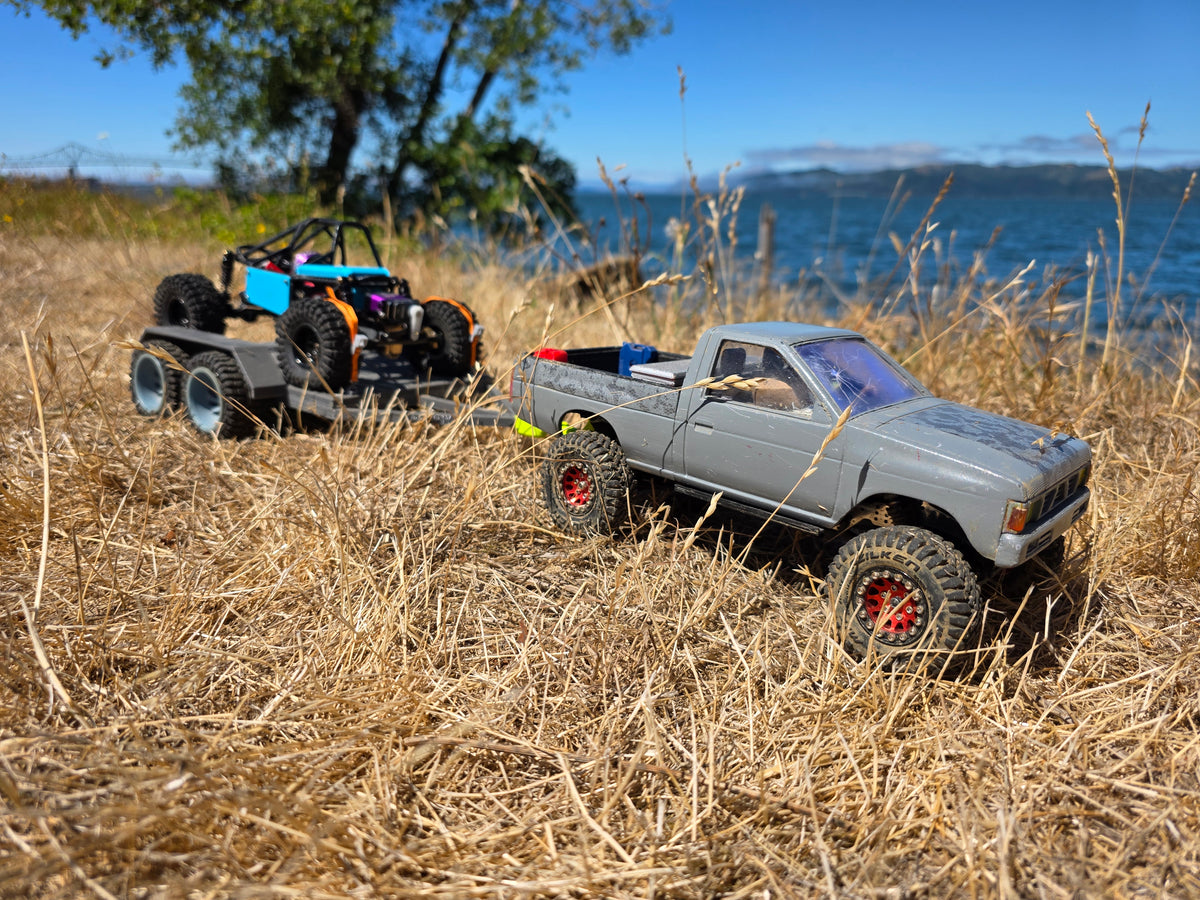 1/24 scale Nissan D21 RC pickup truck with GRC Mallard buggy on trailer, Columbia River